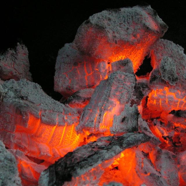 Lumps of red-hot charcoal with grey ash