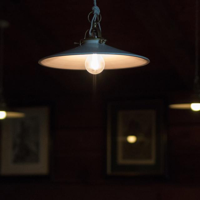 A single pendant lamp glowing in a dim room